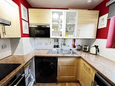 a kitchen with a sink and a dishwasher at The Maltings Retreat in Inverkeithing
