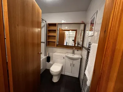 a small bathroom with a toilet and a sink at The Maltings Retreat in Inverkeithing