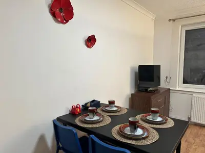 a dining room table with three cups of coffee on it at Private main door Two Bedrooms Apartment in Edinburgh