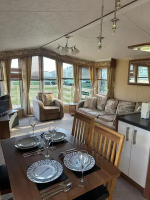 a living room with a table and a couch at Aspen Scenic 53 in Ardentinny