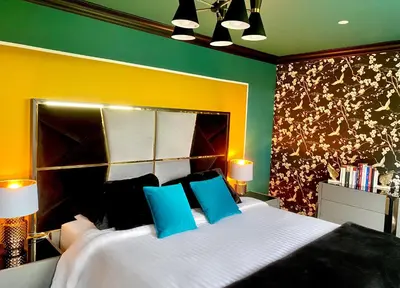 a bedroom with a large white bed with blue pillows at Private Bedroom & Bathroom with Amazing View in Quirky Townhouse in Glasgow