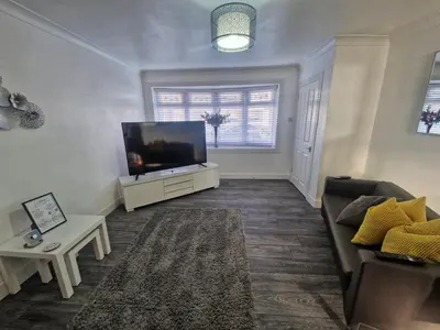 a living room with a large flat screen tv at Cozy Shotts House with 2 Bedrooms in Kirk of Shotts