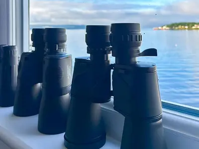 a group of blue bottles sitting on a window sill at Holy Loch View in Strone