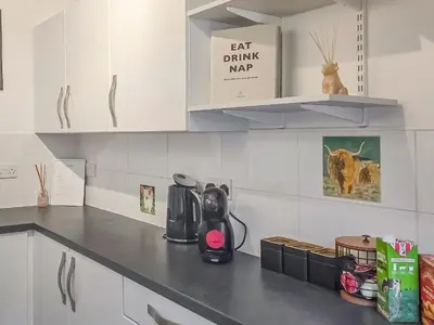 a kitchen counter with a coffee maker on it at Holy Loch View in Strone