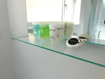 a glass counter in a bathroom with some products on it at No 1 - 2 bedroom apartment in Lanark Town Centre in Lanark