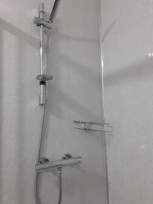 a shower with a glass door with a shower head at No 5 - Modern 2 bedroom Apartment in Lanark Town Centre in Lanark