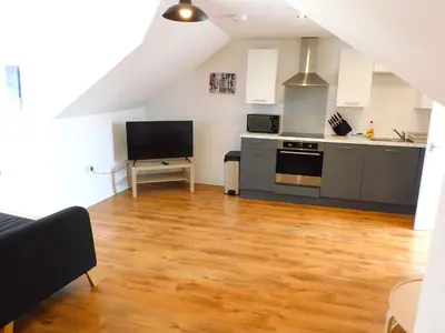 a living room with a kitchen and a living room at No 7 - Modern 1 Bedroom Apartment in Lanark Town Centre in Lanark