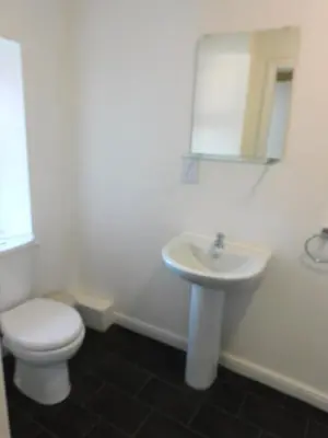 a bathroom with a white toilet and a sink at No 9 - Modern 3 Bedroom Apartment in Lanark Town Centre in Lanark