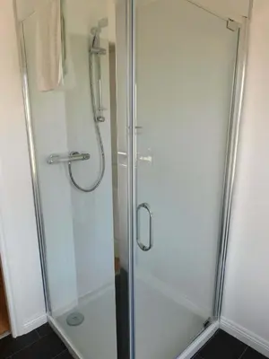 a shower with a glass door in a bathroom at No 11 - Contemporary 2 Bedroom Apartment in Lanark Town Centre in Lanark