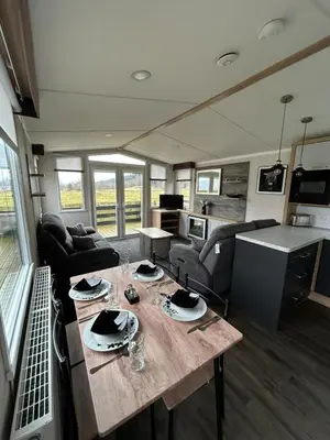 a living room with a table in a house at Swift Bordeaux Sea View 10 in Ardentinny