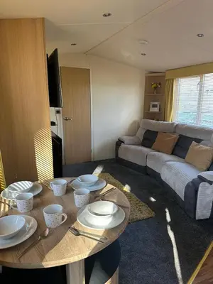 a living room with a table and a couch at Swift Serenity 50 in Ardentinny