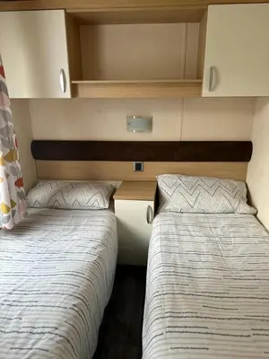 two beds are in a small room withermottermottermott at Swift Serenity 50 in Ardentinny