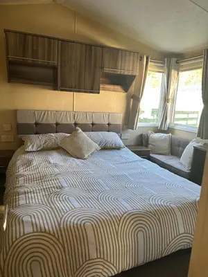 a bedroom with a large bed and a couch at Winchester 23 in Ardentinny