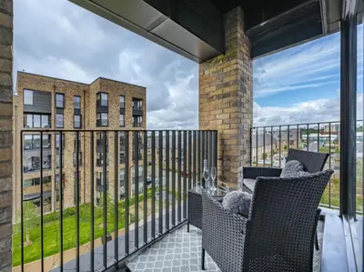 a balcony with a table and chairs on a balcony at En-suite - Glasgow Riverside in Glasgow