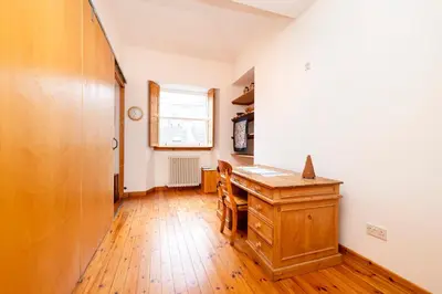 an office with a wooden desk and a window at Edinburgh New Town Deluxe Apartment with Terrace in Edinburgh