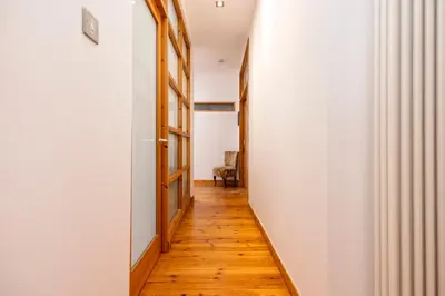 a hallway with wooden floors and white walls at Edinburgh New Town Deluxe Apartment with Terrace in Edinburgh