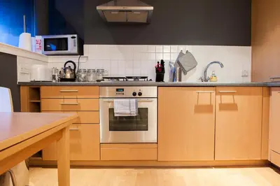 a kitchen with a stove and a sink at Bright & Stylish West End Apartment in Edinburgh