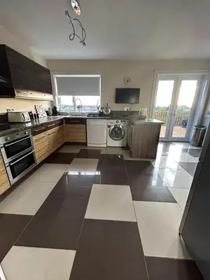 a large kitchen with a sink and a dishwasher at The Old High Road, North Ayrshire in Stevenston