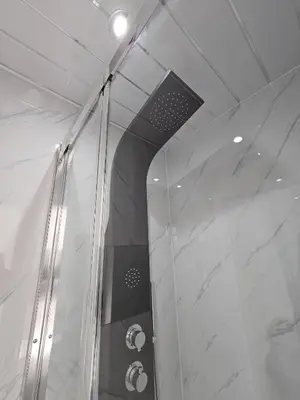 a shower with a glass wall in a bathroom at Central Hotel Edinburgh in Edinburgh