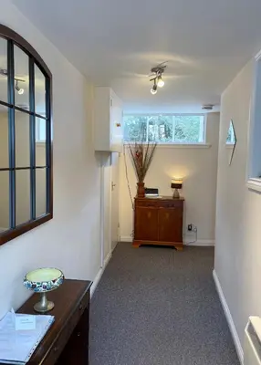 an empty hallway with a desk and a window at 3 Telford Mews in Dumfries