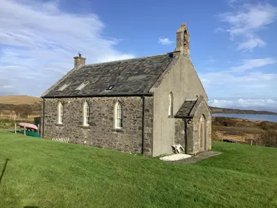 an old stone church on a grassy field at Leargy House in Isle of Jura