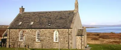 an old stone church in the middle of a field at Leargy House in Isle of Jura
