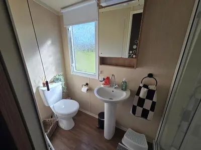 a small bathroom with a toilet and a sink at The Canny View at Three Lochs Holiday Park in Balminnoch 3 bedroom sleeps upto 8 guests in Newton Stewart