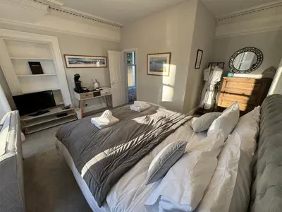 a bedroom with a large bed and a television at Crannaig House in Aberfoyle