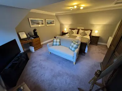 an overhead view of a bedroom with a bed and a chair at Crannaig House in Aberfoyle
