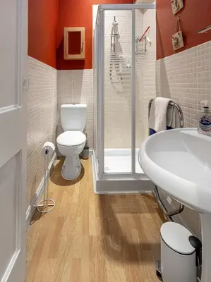 a bathroom with a toilet and a shower and a sink at Coastal Charm in Kingarth