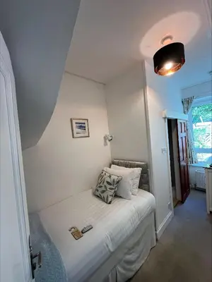 a small bedroom with a bed in a room at Glenroy Guest House in Oban