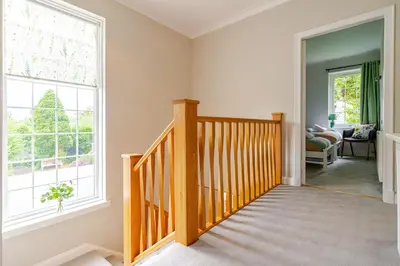 a wooden staircase in a home with a large window at Amulree, Edinburgh City in EDI