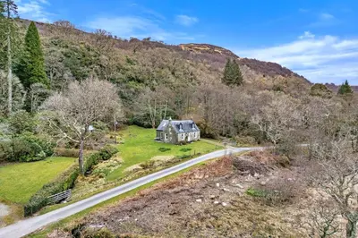 an aerial view of a house on a road at Finest Retreats - Lochead Cottage in Achahoish