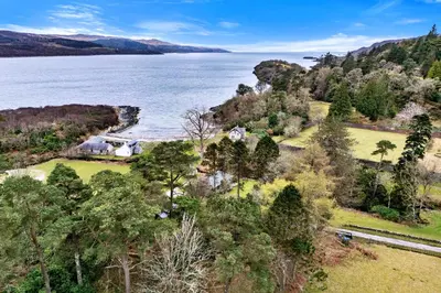 an aerial view of a house next to a body of water at Finest Retreats - The Turbine House in Achahoish