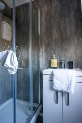 a bathroom with a shower and a sink at Carradale House in Falkirk