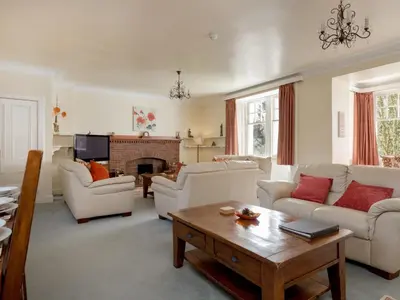 a living room with white furniture and a fireplace at Holiday Home Balcraig House by Interhome in Straiton