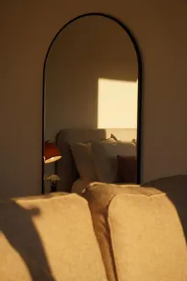 a bedroom with a bed and a large mirror at The Barn, Summerhill Farm Stays in Balmaclellan