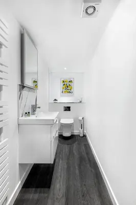 a white bathroom with a sink and a toilet at Castle Street Apartments - Luxury Kilchattan Apartment in Rothesay