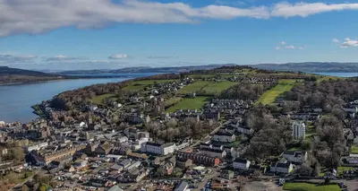 an aerial view of a city next to the water at Castle Street Apartments - Luxury Kilchattan Apartment in Rothesay