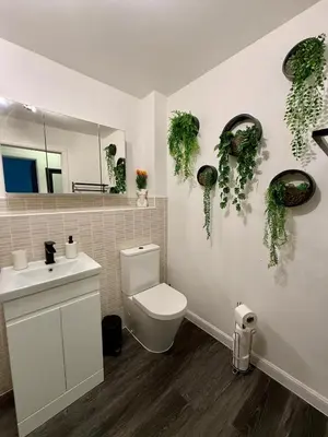 a bathroom with a toilet and a sink and a mirror at 2 Bedroom Apartment near Glasgow City Centre, Celtic Park and Emirates Arena in Glasgow