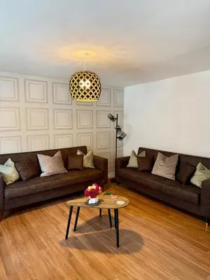 a living room with two couches and a coffee table at 2 Bedroom Apartment near Glasgow City Centre, Celtic Park and Emirates Arena in Glasgow