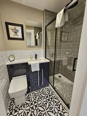 a bathroom with a toilet and a sink and a shower at Comely Bank Coorie in Edinburgh
