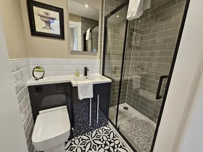 a bathroom with a toilet and a sink and a shower at Comely Bank Coorie in Edinburgh