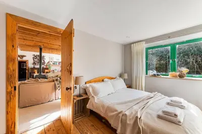 a bedroom with a large bed and a window at B&B on Beautiful Organic Homestead, Edinburgh in Loanhead