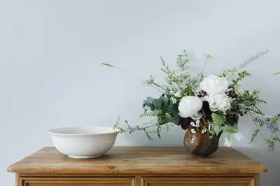 a table with a bowl and a vase of flowers at B&B on Beautiful Organic Homestead, Edinburgh in Loanhead