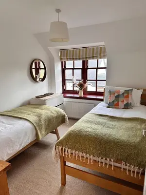 a bedroom with two beds and a window at Drymen View in Drymen