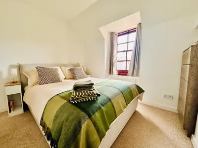 a bedroom with a large bed and a window at Drymen View in Drymen