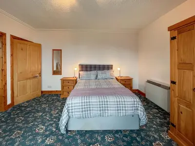 a bedroom with a bed and two night stands at Glengilp Apartment - Uk49317 in Ardrishaig