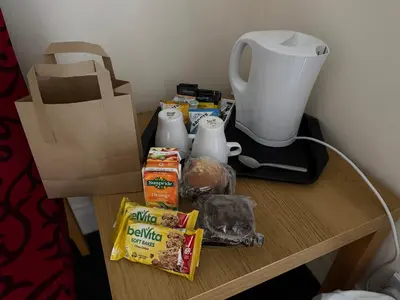 a table with a coffee maker and food on it at Belton House Guest Rooms in Wanlockhead