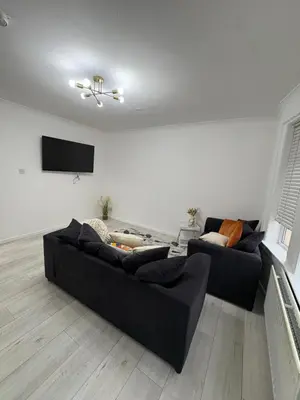 a living room with two couches and a flat screen tv at Cozy 3 Bed Home, Free Parking 8 min to City Centre in Cowlairs